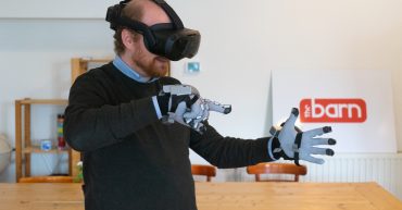 Guy with VR headset and SenseGloves